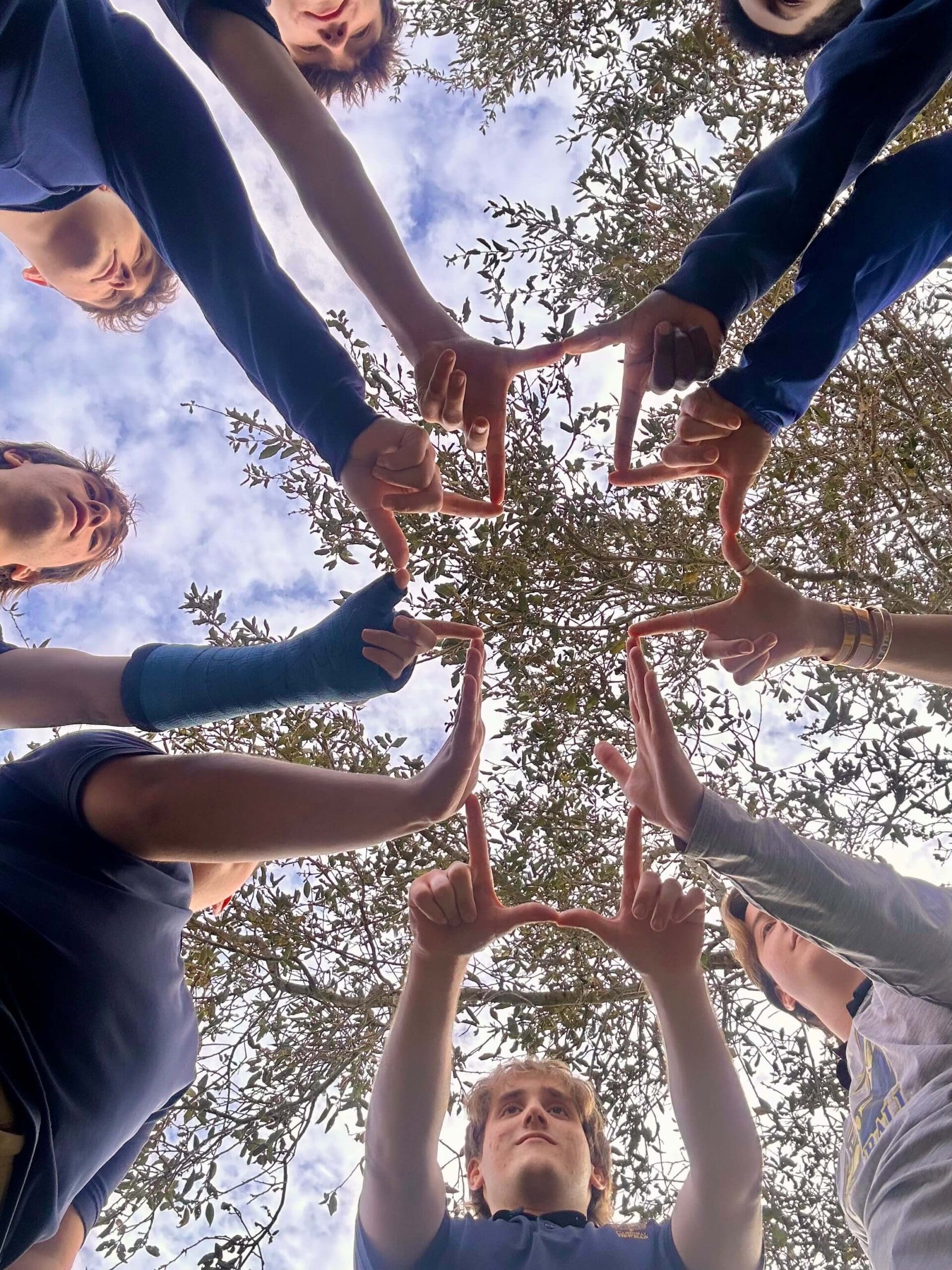 Kids making a cross